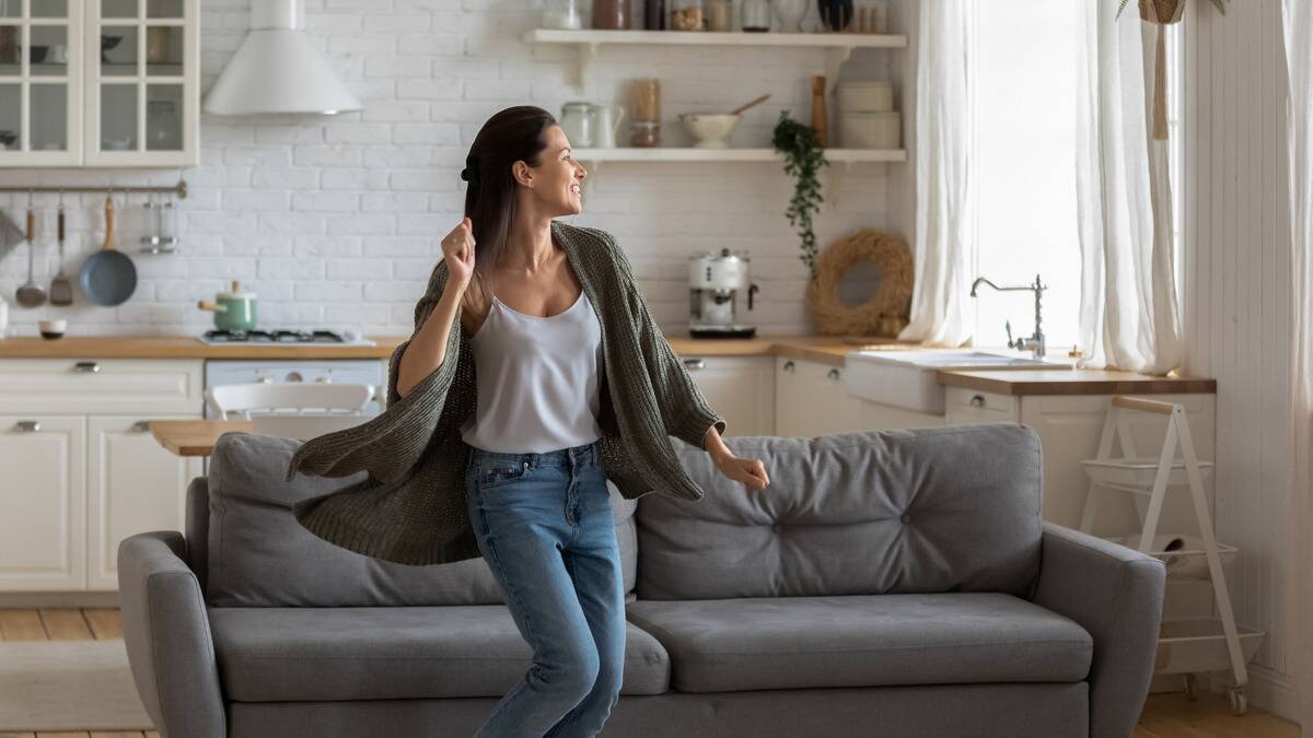 A woman dancing in her living room.