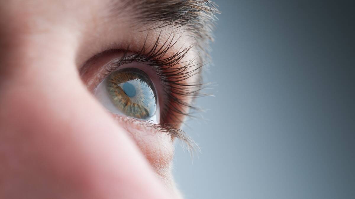 A closeup of a person's eye looking upward.