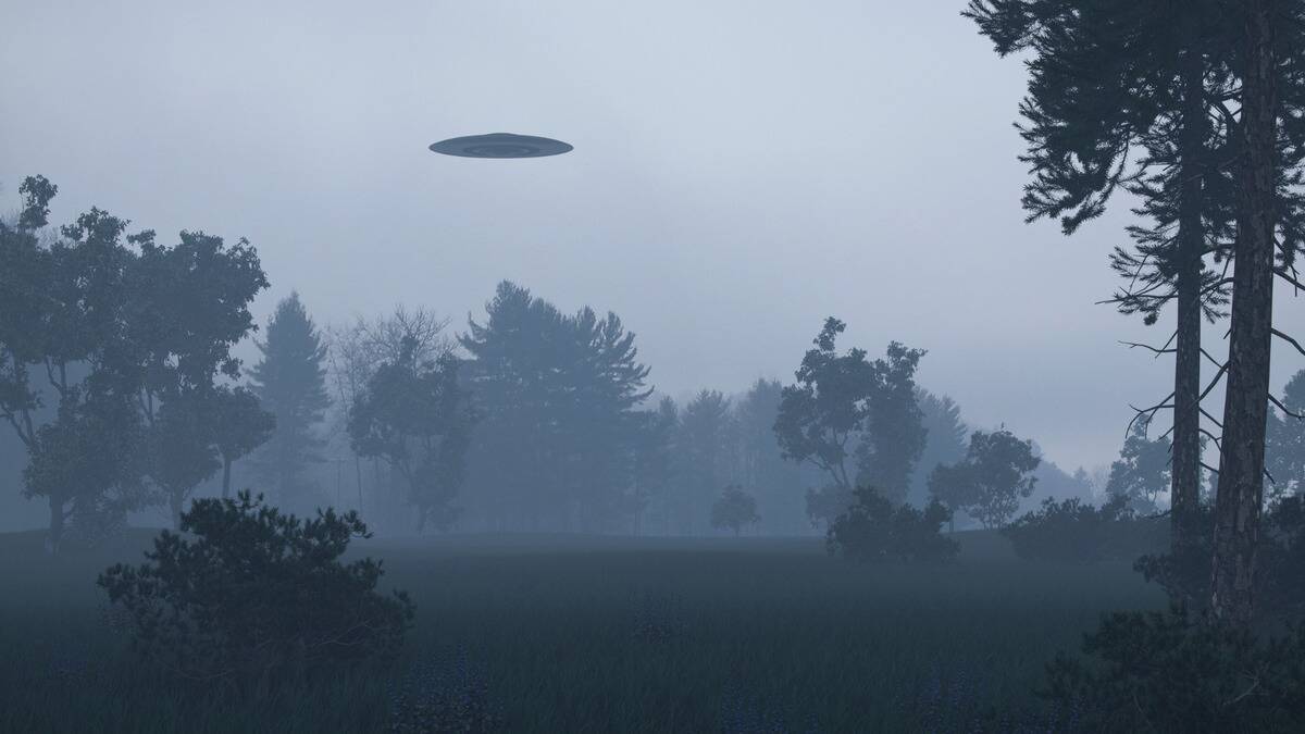 A UFO visible in a foggy sky above a field.