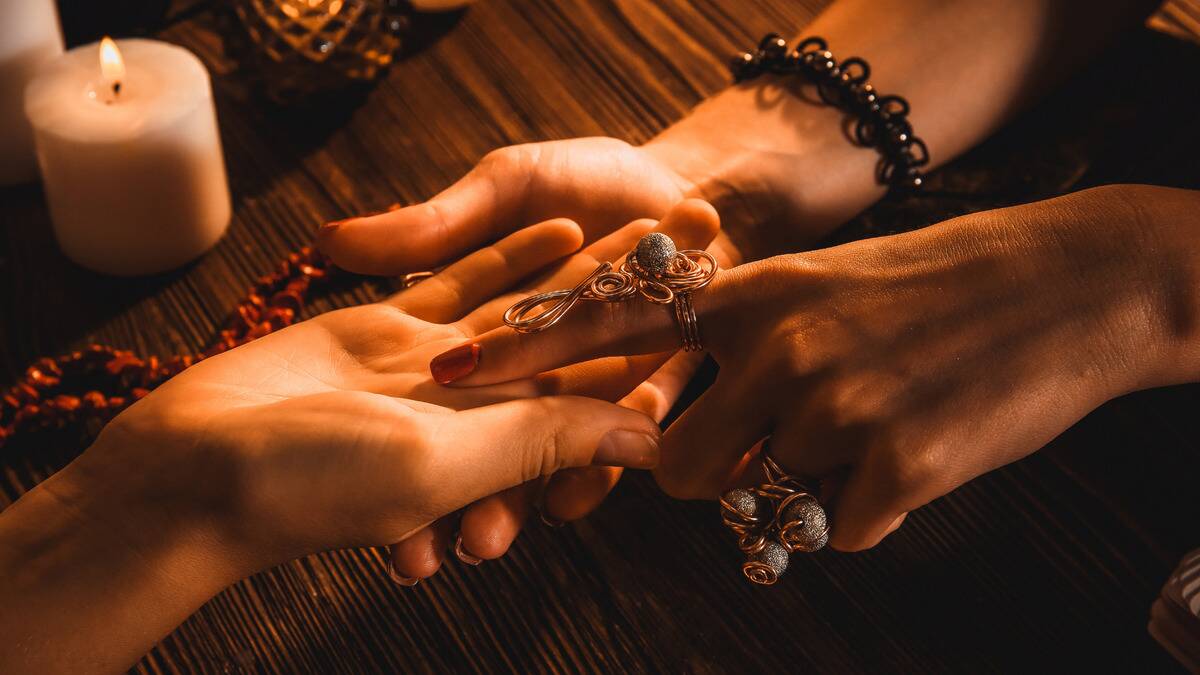 A close photo of someone giving a palm reading.