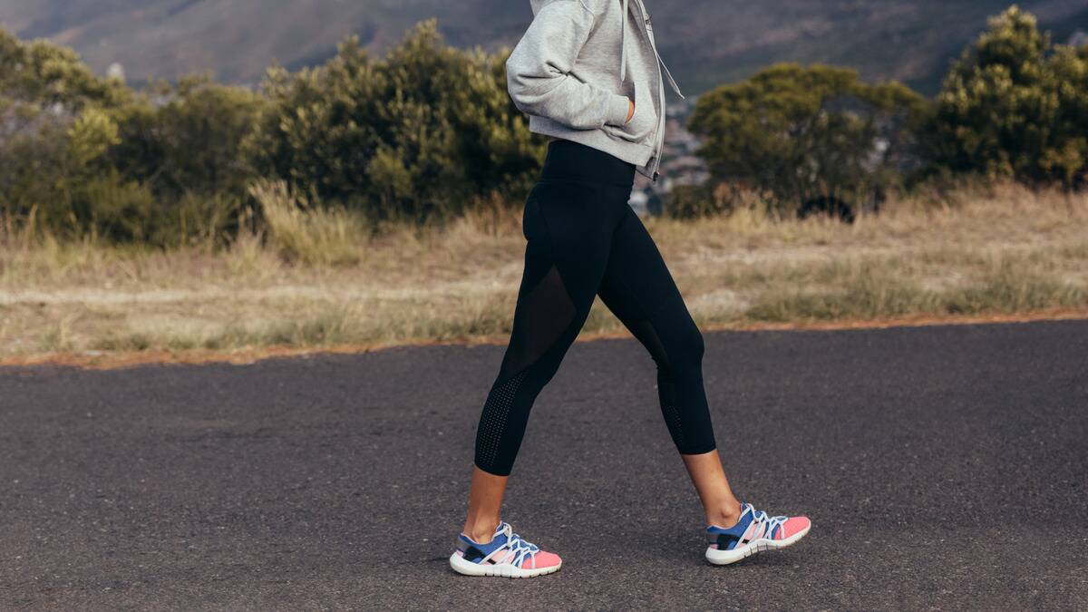 A woman walking down a road.