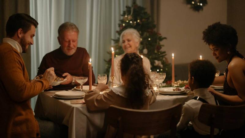 A family gathered around a table for Christmas dinner.