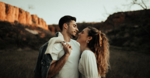 woman looks up to man smiling