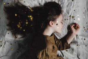 woman on pillow with a bunch of scattered stars