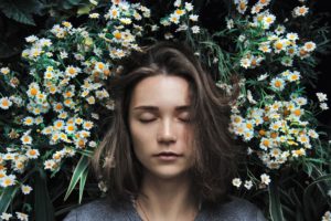 woman sleeping on a bed of flowers