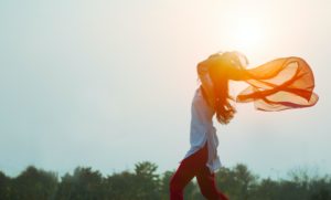 woman with scarf flying behind her