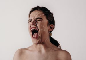 woman screams with wires all over face