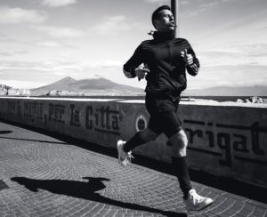 black and white photo of man running on concrete