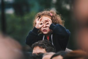 woman makes binocular shapes with her hands