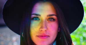 woman with rainbow lights reflecing on her face