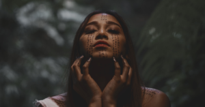 woman with face art eyes closed and facing up