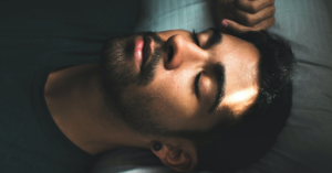 man laying down with eyes closed