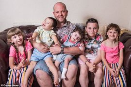 family sits on the couch for picture