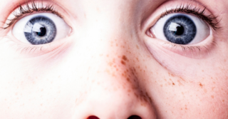 scared blue eyes close up on face with freckles