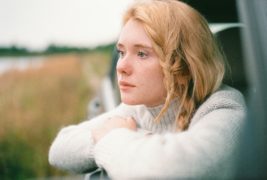 woman looking out car window and thinking